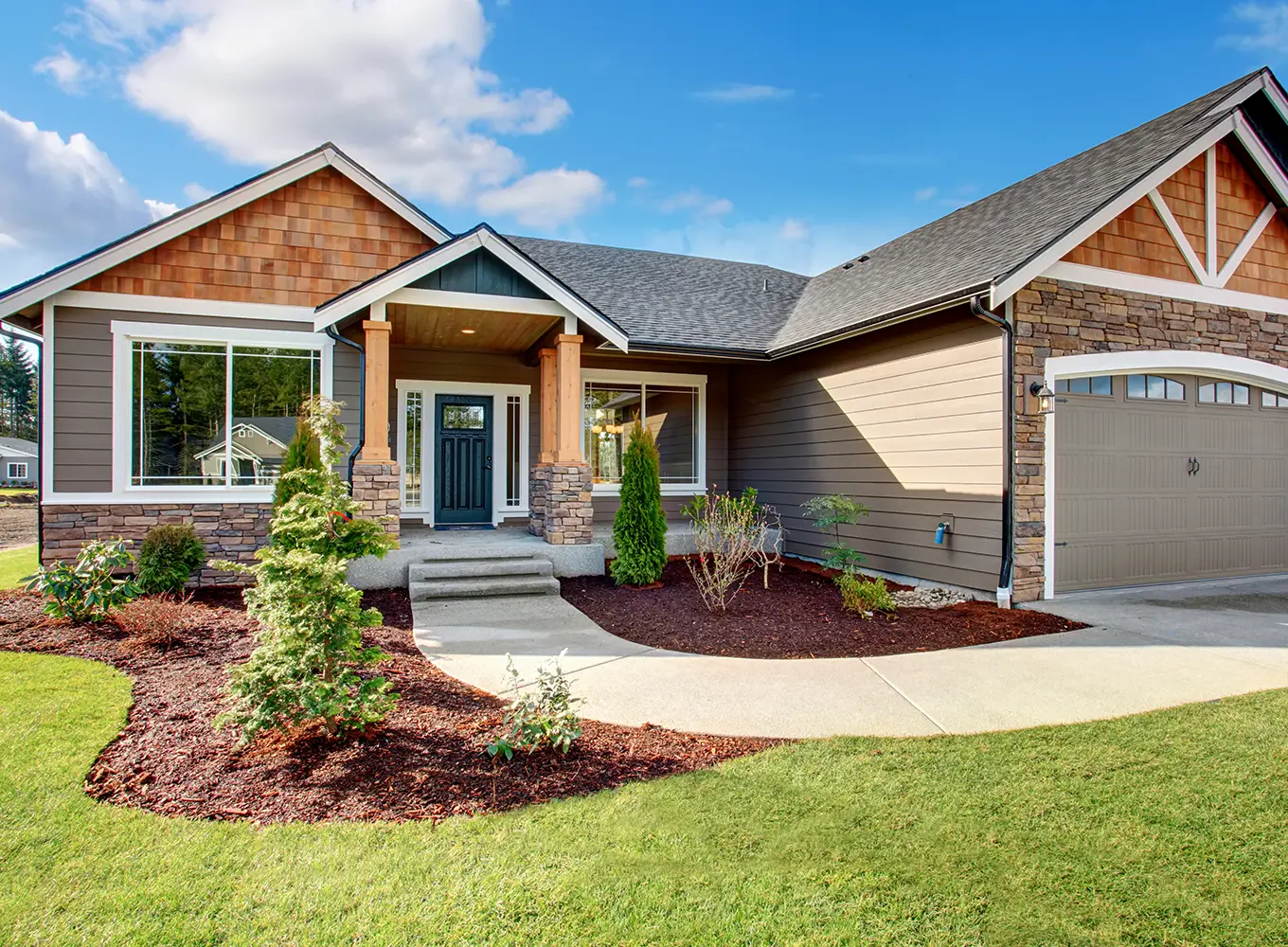 residential home with a landscape design with added plants and softscaping in Springfield IL