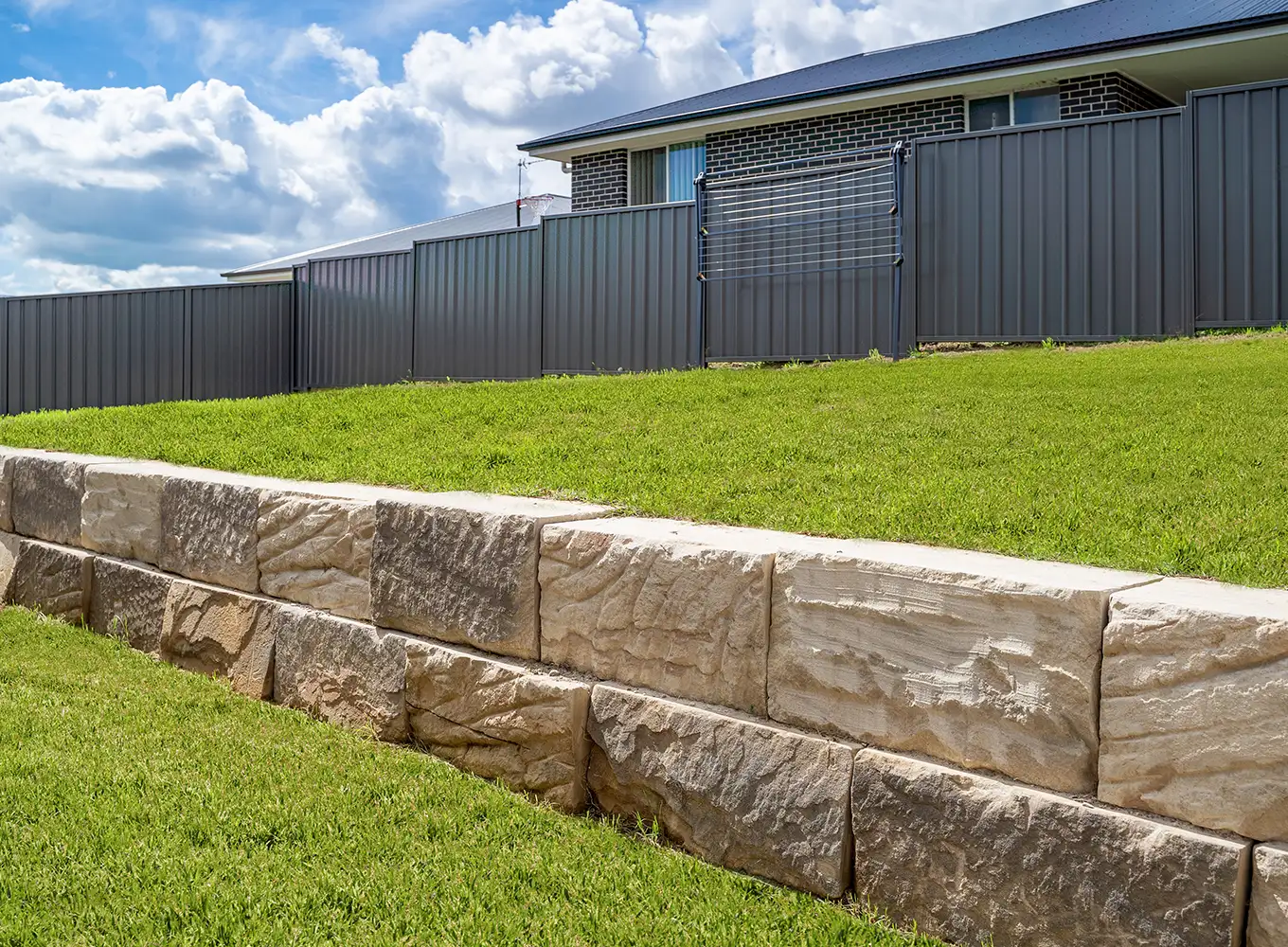 short retaining wall installed in a backyard
