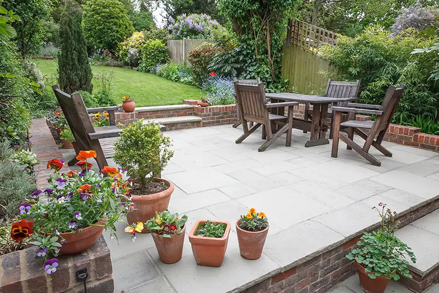Taylormade Landworks—A luxury patio with potted flowers in the springtime in Springfield, IL.