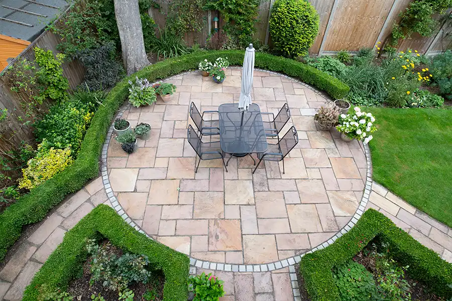 Taylormade Landworks—A circular garden patio with freshly jet-washed paving stones on a property in Springfield, IL.